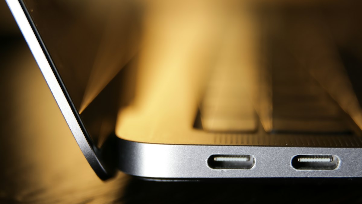 Close-up of laptop charging ports in warm light