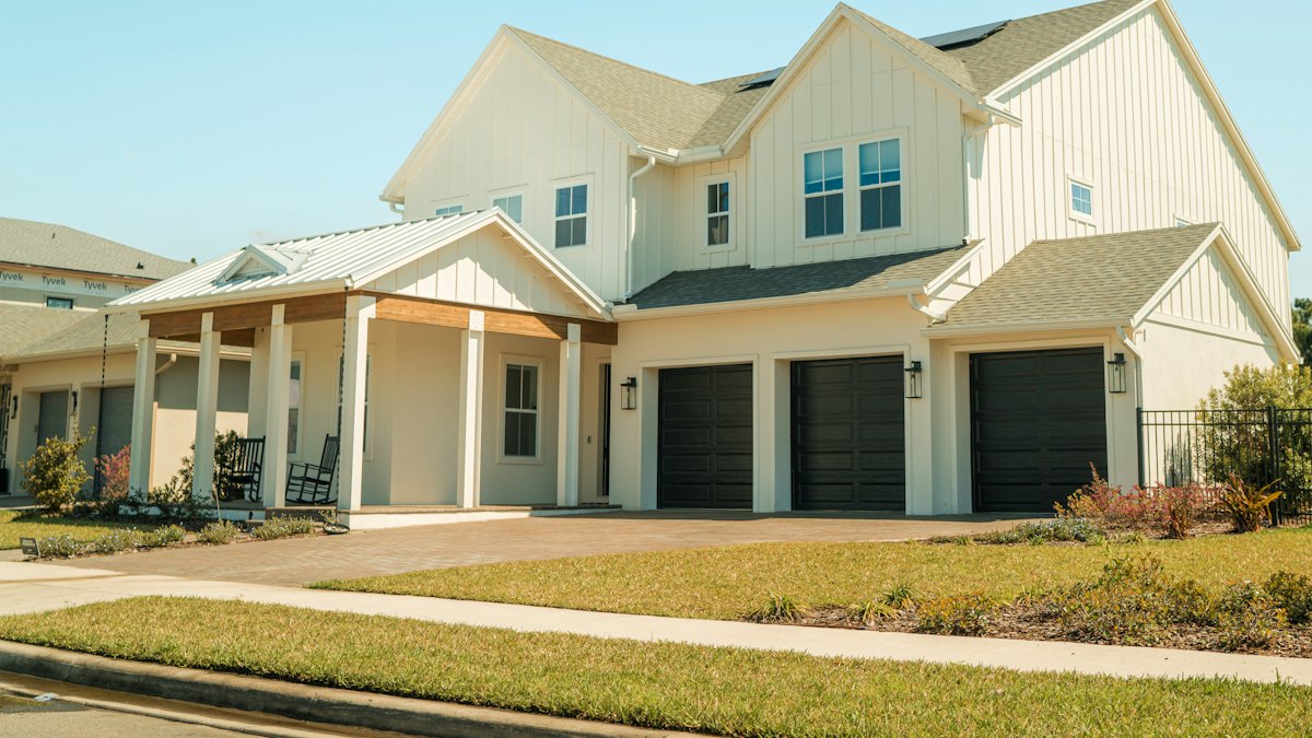 Newly built white two-story house with a three-car garage